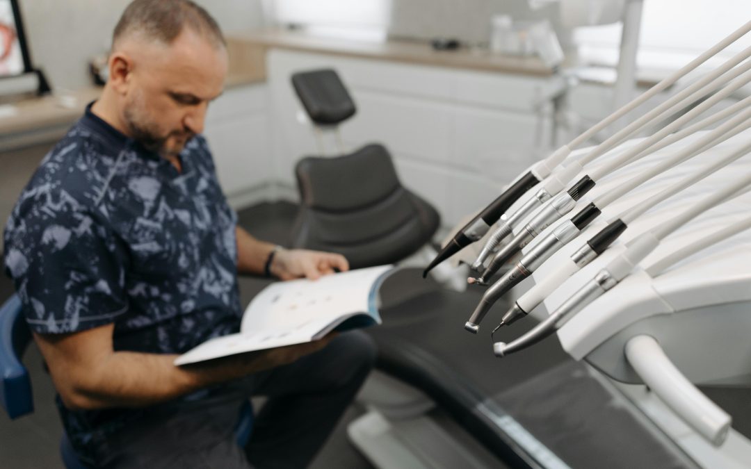 Dentist reading how to sell a dental practice in Australia for his dental practice