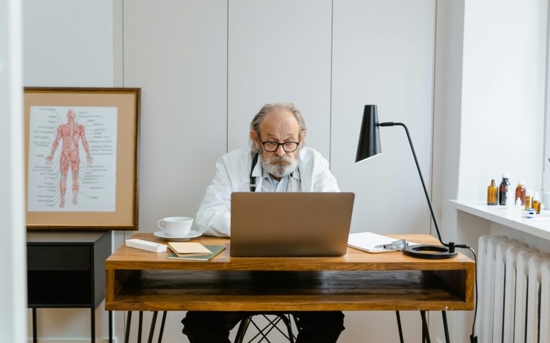 medical business owner on his laptop looking at how to sell his medical business in australia