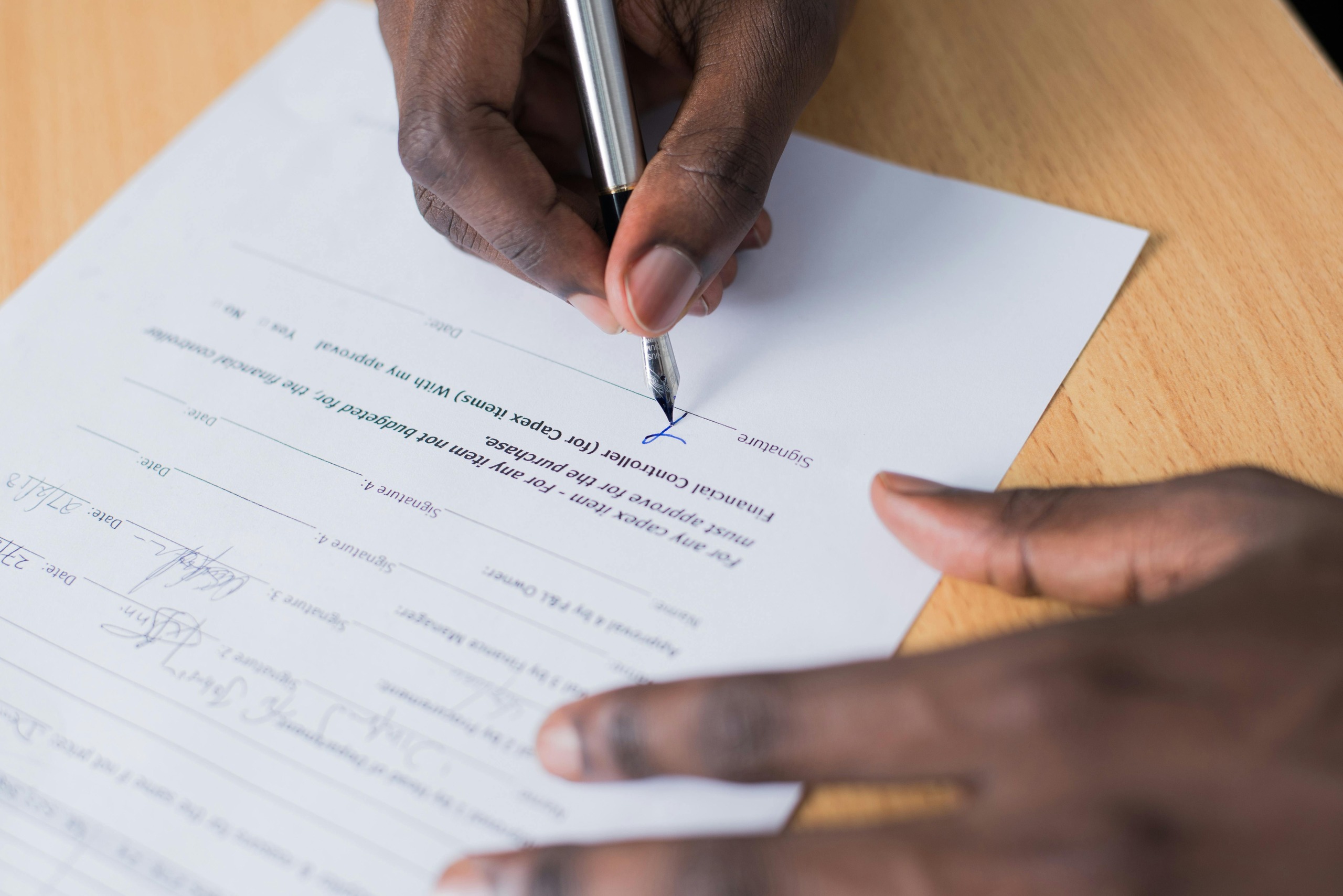 man signing physiotherapy practice legal paperwork in australia