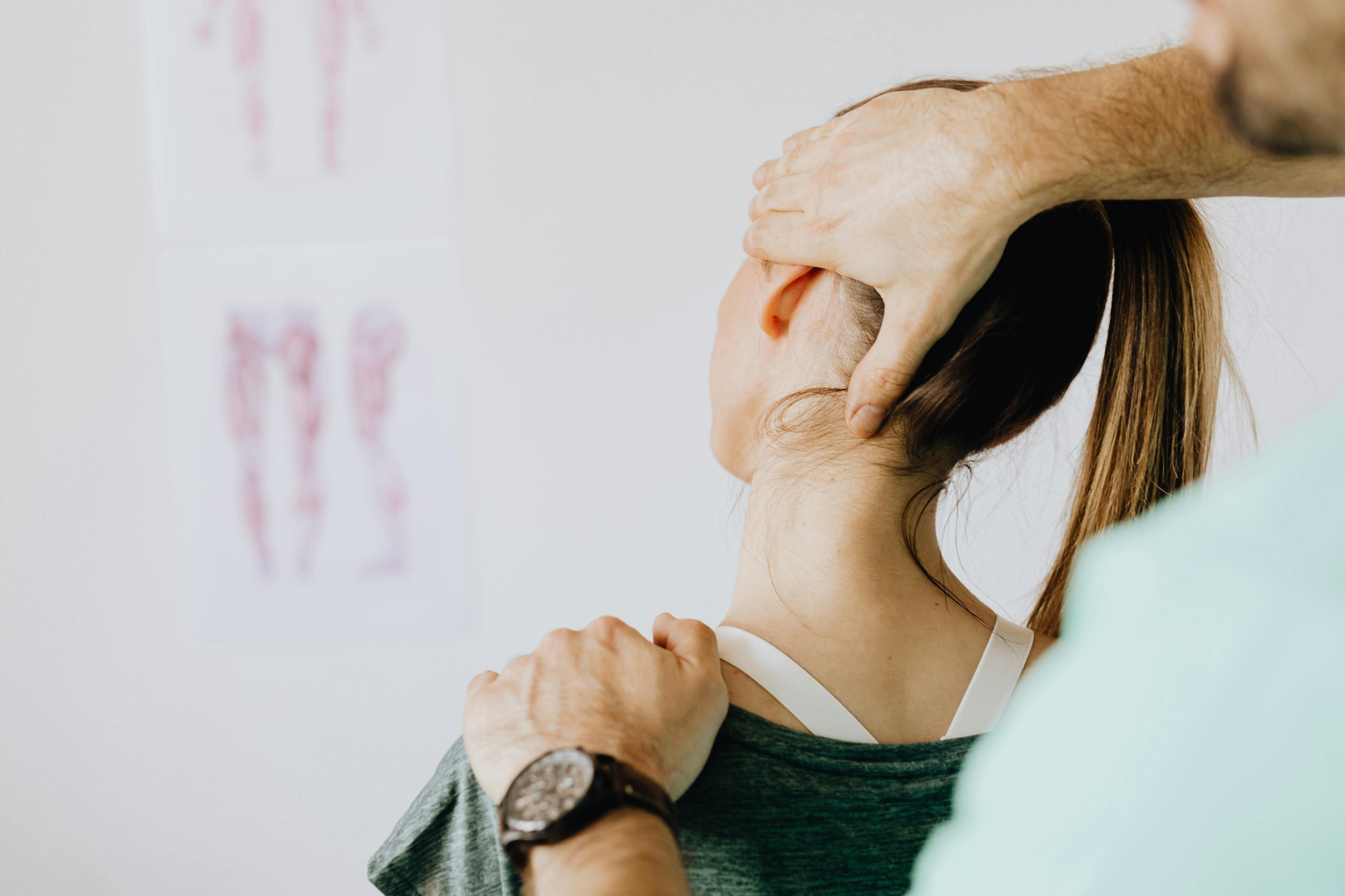 physiotherapis stretching his client's neck